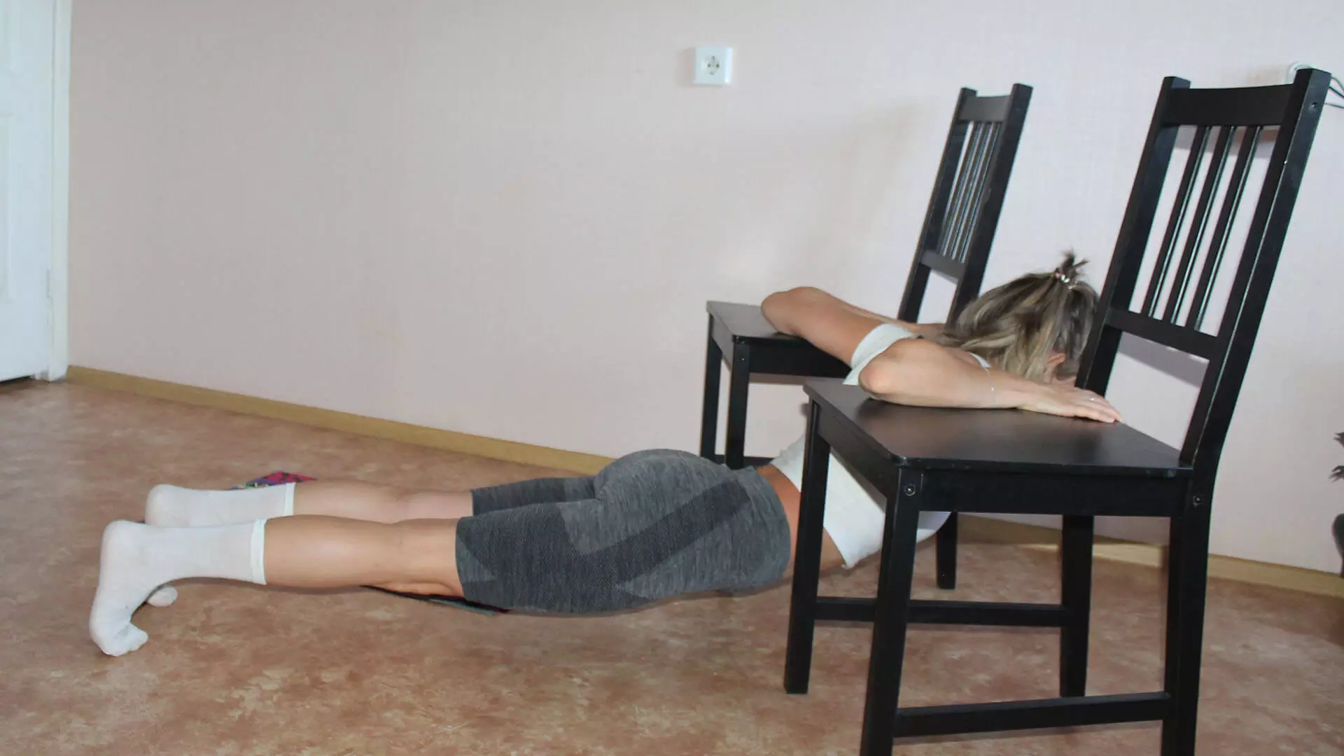 Stretching the pectoralis minor and pectoralis major with chairs: exercise photo.